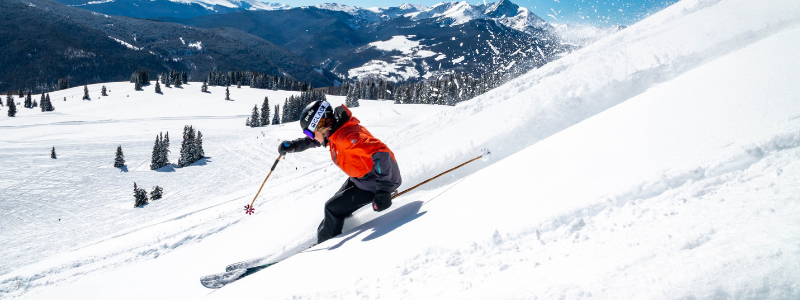 Person Skiing Down Mountain in Colorado